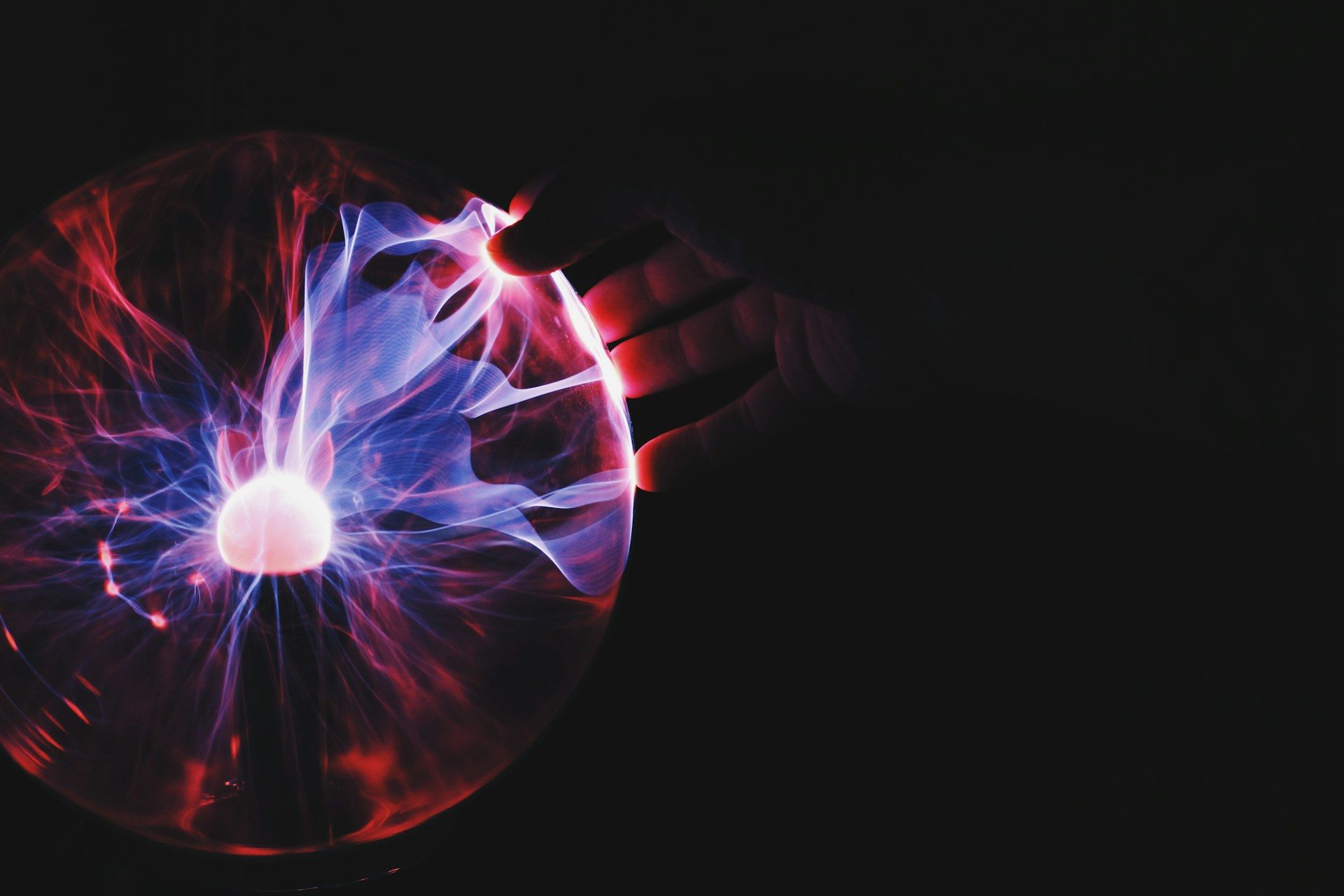 human hand holding plasma ball